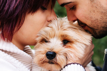 Close-up of a couple of young boys with their puppy giving them a kiss. concept of family, humans and dogs, animal care.