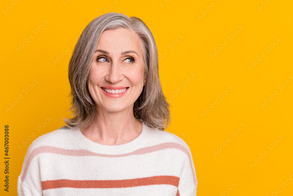 Sticker Photo portrait elder woman wearing striped pullover smiling looking copyspace dreamy isolated vivid yellow color background