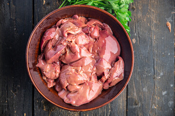 raw chicken liver offal piece meal snack on the table copy space food background rustic. top view keto or paleo diet - obrazy, fototapety, plakaty