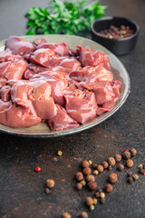 raw chicken liver offal piece meal snack on the table copy space food background rustic. top view keto or paleo diet