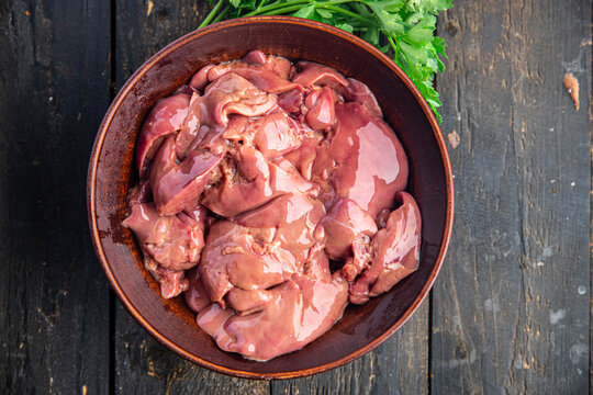 raw chicken liver offal piece meal snack on the table copy space food background rustic. top view keto or paleo diet