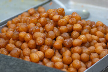Pile of Awamat sweets, also known as Lokmet El Kady, and Lokaymat, Lebanese crisp doughnut balls,...