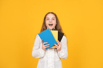 Fototapeta premium amazed child hold school book on yellow background, study