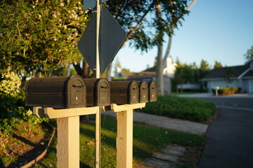 Old black mailbox under sunset sunlight