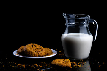 Milk in a jug with chocolate chip cookies