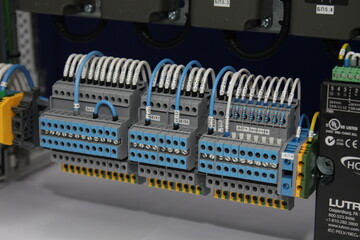 Multi-level pass-through terminals for connecting wires in an electrical panel.