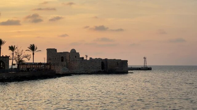 The city of Sidon in Lebanon. Sidon Sea Castle, built by the crusaders - Saida corniche and building. Sidon sea at sunset
