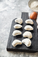 vareniki homemade raw dumplings stuffed ready to eat meal snack on the table copy space food background rustic 