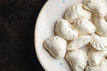 vareniki homemade raw dumplings stuffed ready to eat meal snack on the table copy space food background rustic 