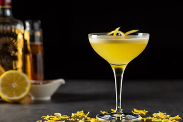Luxury cocktail and cocktail shaker on black stone background