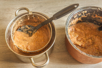 Rubbing applesauce through a sieve