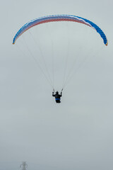 Paraglider Pilot Flying in the Sky - 467008820