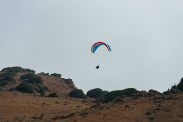 Fototapeta na wymiar Paraglider Pilot Flying in the Sky