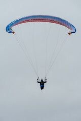 Paraglider Pilot Flying in the Sky - 467008828