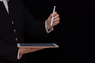 tablet and stylus in female hands on black background, online business, e-commerce, digital design background