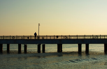 Man standing alone on the pier.Loneliness.