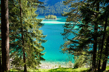 picturesque turquois alpine lake Eibsee (yew lake) by the foot of mountain Zugspitze in Bavaria...