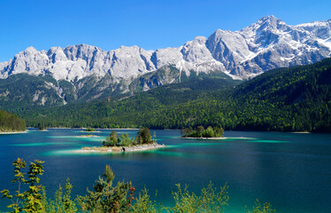 Fototapeta na wymiar picturesque turquois alpine lake Eibsee (yew lake) by the foot of mountain Zugspitze in Bavaria (the German Alps, Garmisch-Partenkirchen, Grainau, Bavaria, Germany) 