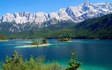 picturesque turquois alpine lake Eibsee (yew lake) by the foot of mountain Zugspitze in Bavaria...