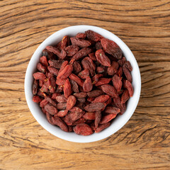 Goji berry in a bowl over wooden table