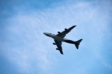 Passenger plane flying on blue sky background