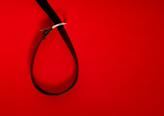 A belt in the form of a loop, as a sign of domestic violence.