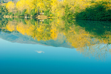 autumn landscape and reflection in the lake.