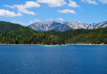 picturesque turquois alpine lake Eibsee (yew lake) by the foot of mountain Zugspitze in Bavaria...