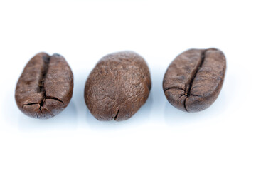 Macro photography of three coffee beans isolated on white