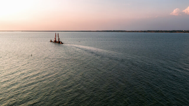 Black sea in Ukraine. Kinburn Spit. Sunset and ship in sea