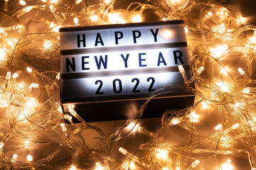 Happy New Year 2022. Christmas lights with the inscription