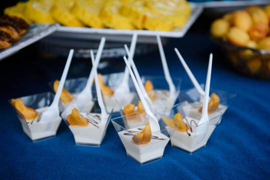 Individual panna cotta desserts on a party table