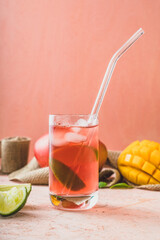 drink coctail prosecco rose in glass
exotic fruits mango lime on peach background pink background delicate colors