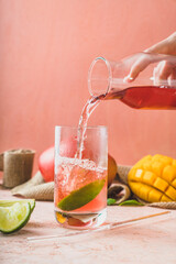 drink coctail prosecco rose in glass
exotic fruits mango lime on peach background pink background delicate colors