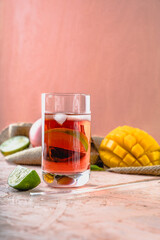 drink coctail prosecco rose in glass
exotic fruits mango lime on peach background pink background delicate colors