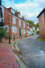 Fototapeta na wymiar UK, Lewes, 31.10.2021: Small houses on a narrow street that climbs the golm. Chapel Hill Street