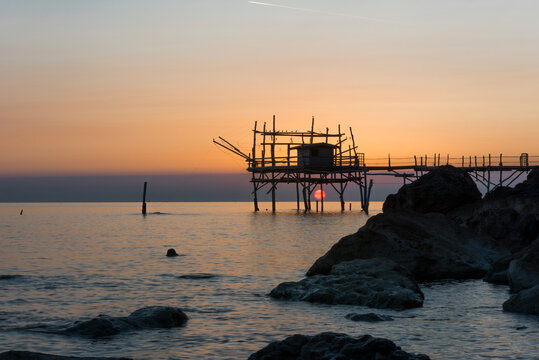 Silhouette of a trabucco at sunset, Pescara, Abruzzo, Italy