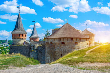 Fototapeta na wymiar Photo of ancient stone castle with many hight towers in Kamyanets-Podilsky with sun