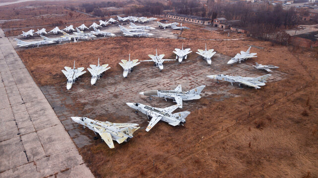 Old decommissioned Su-24 aircraft awaiting disposal at the airport. Autumn, fog, post-apocalypse.