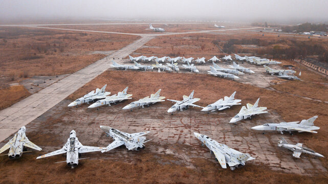 Old decommissioned Su-24 aircraft awaiting disposal at the airport. Autumn, fog, post-apocalypse.