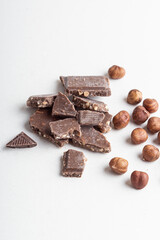 Dark chocolate and peeled hazelnuts. Chocolate with nuts