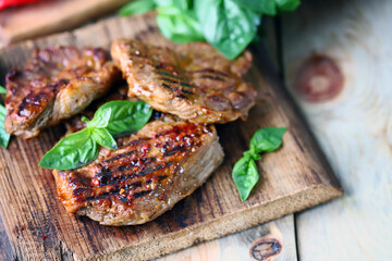 Grilled juicy steak on a wooden board.
