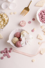 Natural healthy candies with strawberry and white chocolate. Cheese truffles. Process of making vegan sweets