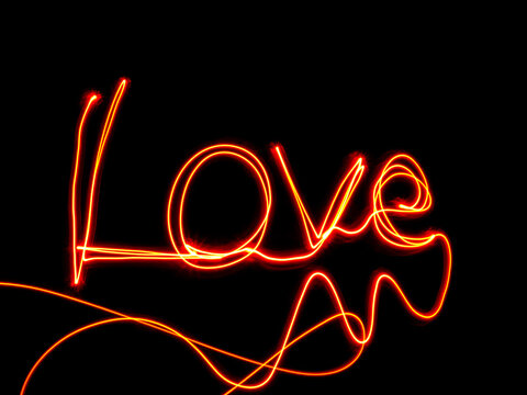 The word 'Love' on a black background, made with light painting.
