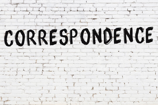 Inscription correspondence painted on white brick wall