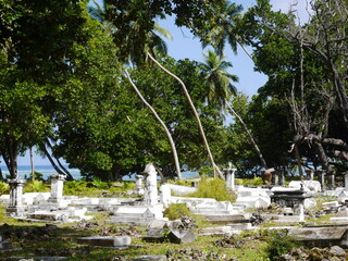 An African Graveyard in Paradise, with Palm Trees and an Indian Ocean Backdrop (La Digue,...