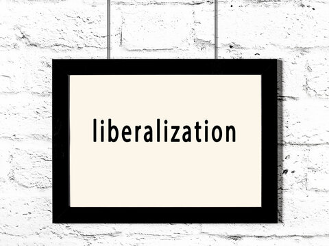 Black frame hanging on white brick wall with inscription liberalization