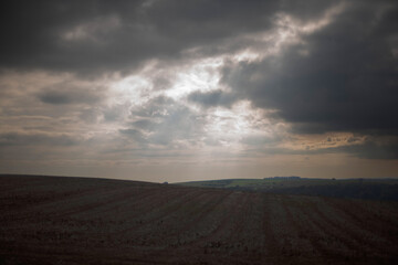 Fototapeta na wymiar clouds and sun ray over the field in France Luxembourg Germany tri countries area