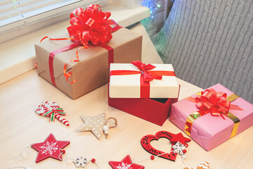 Christmas gifts in packed boxes are on the table at home. Preparation for New Year's Eve and Christmas.