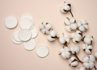 White cotton sponges on beige background. Design for the beauty, medicine and cosmetics industry